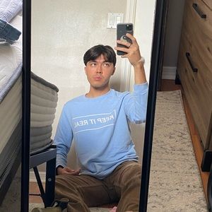 Baby blue “Keep It Real” sweatshirt.